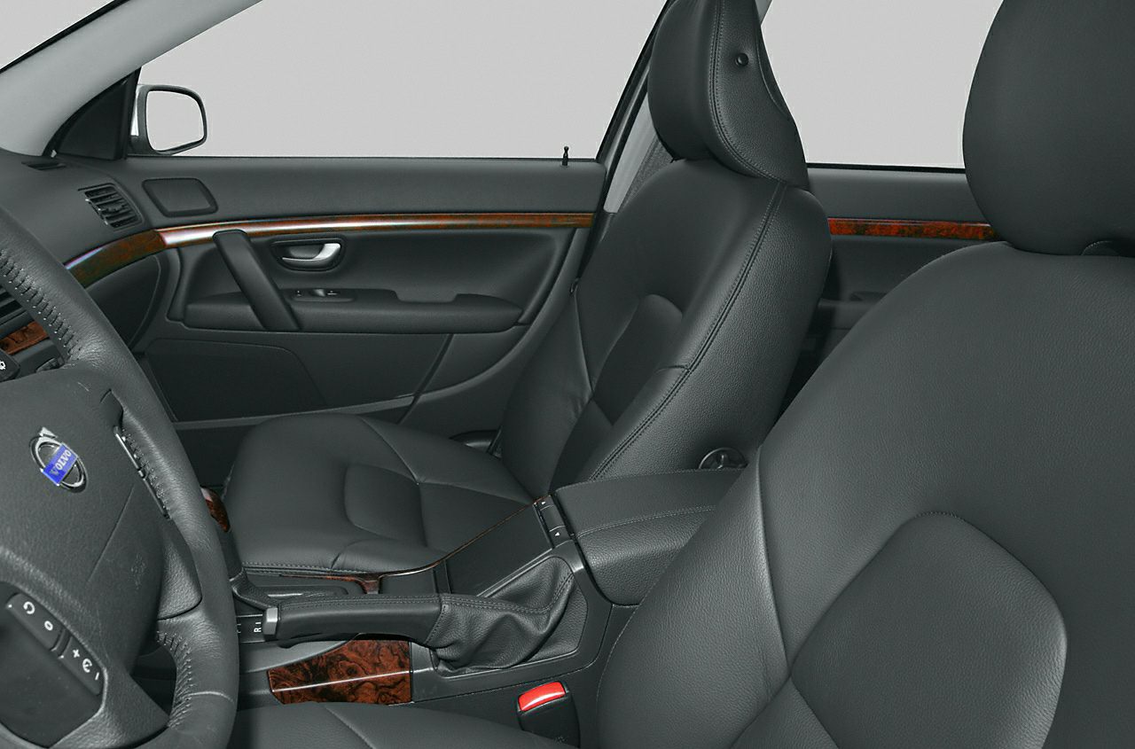 Black leather car interior with wood trim and automatic gearshift
