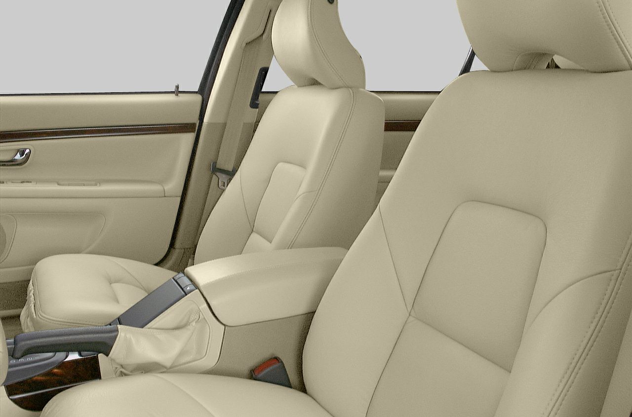 Beige leather seats and wood trim door panel inside modern sedan