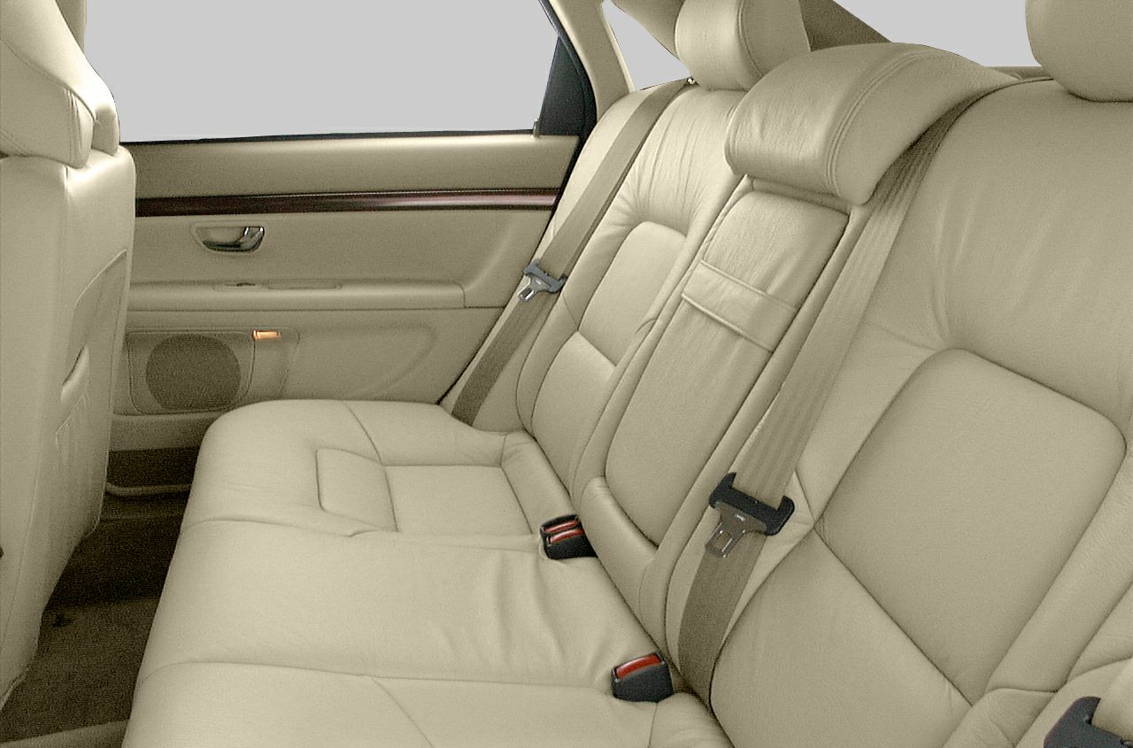 Beige leather rear seats with seatbelts and door panel