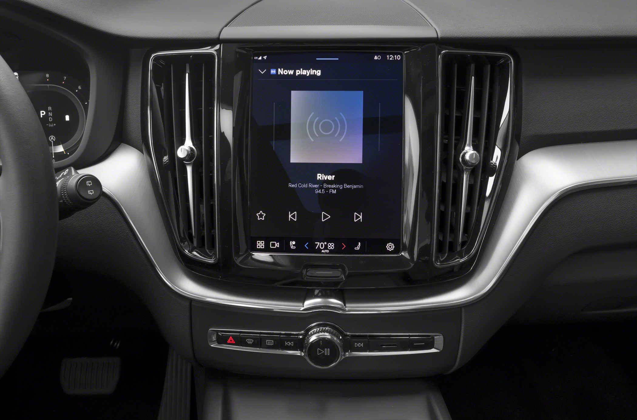 Central touchscreen infotainment with media controls and dual air vents