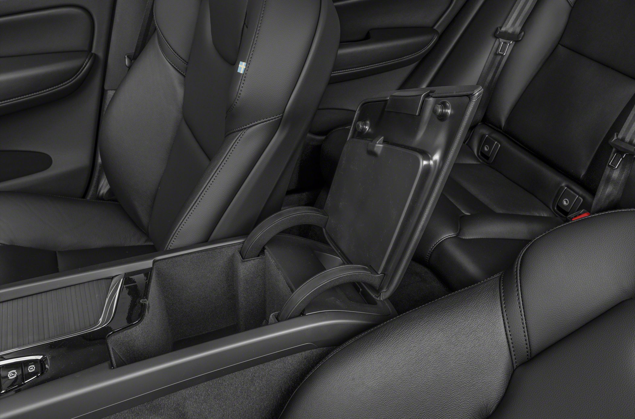 Center console with open storage compartment and black leather seats
