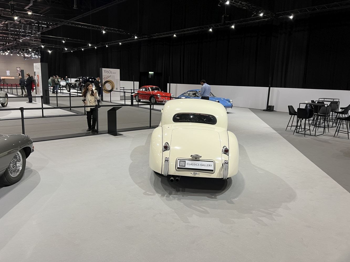 Rear view of vintage classic coupe with rounded design and dual exhausts