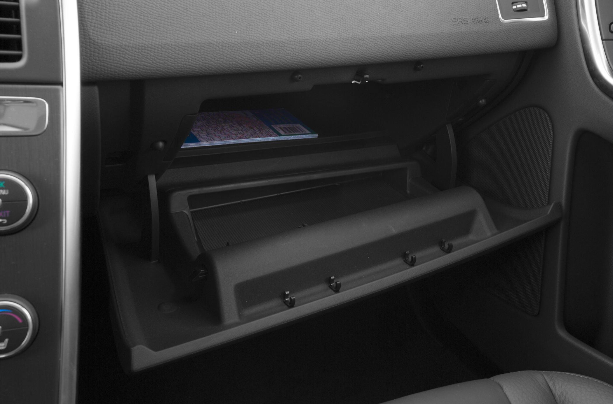 Open glove compartment interior with storage space and dashboard details
