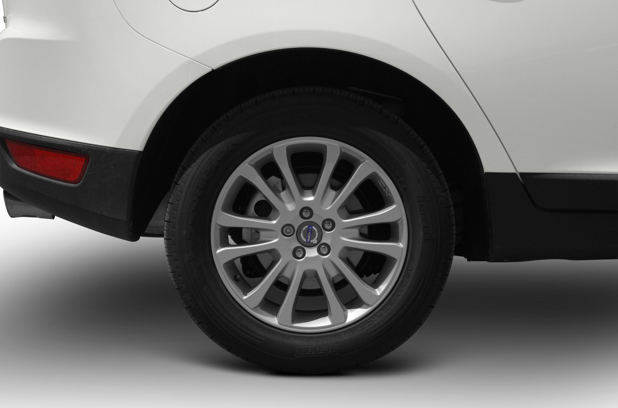 Close-up of Volvo XC60 I alloy wheel and rear fender with rear side reflector