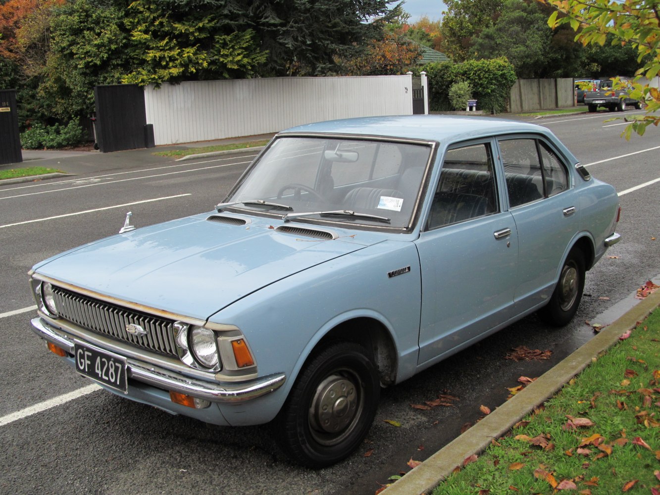 Classic 4-door sedan with vintage grille and round headlights