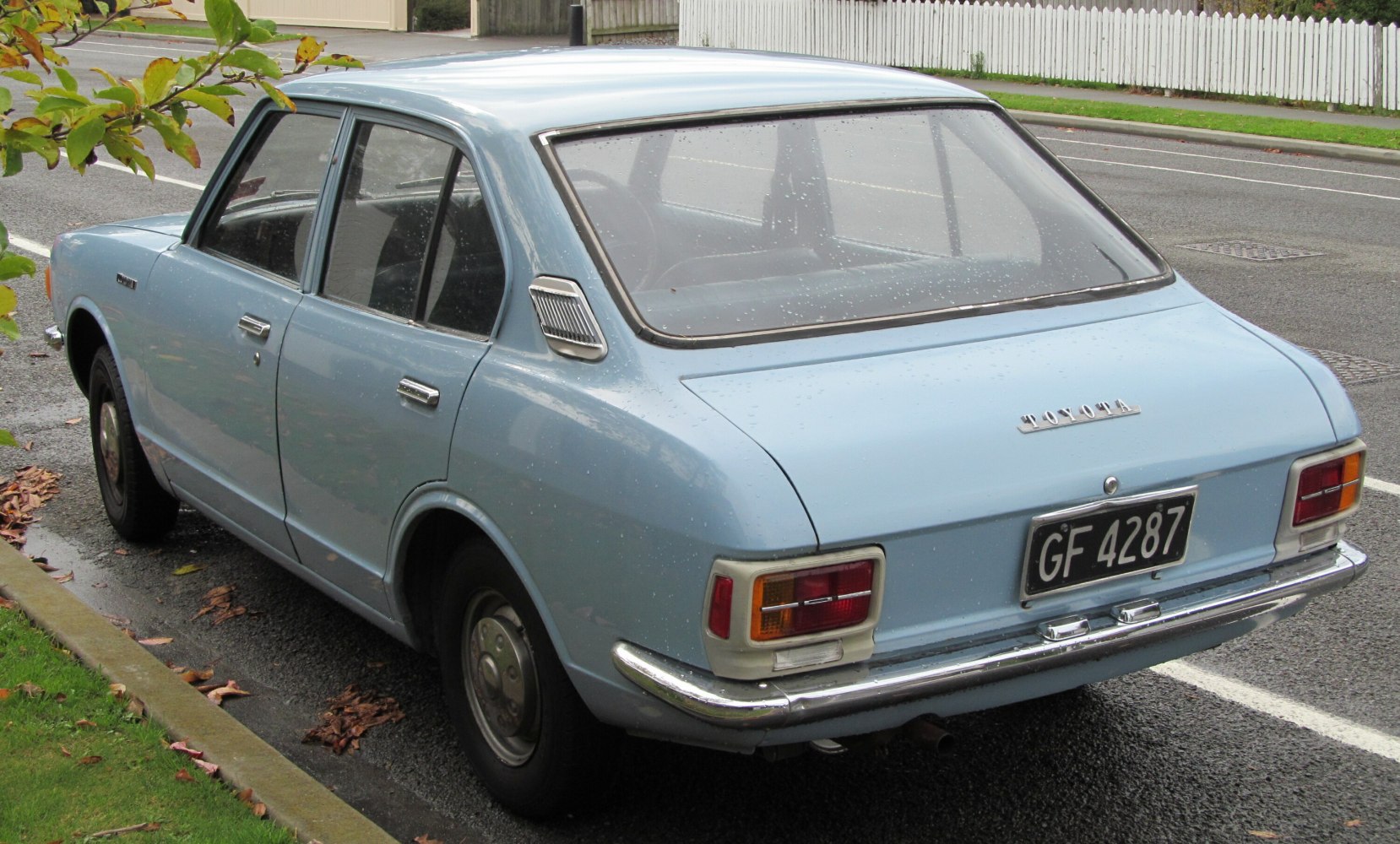 Rear view of classic 4-door sedan with chrome bumpers and vintage tail lights
