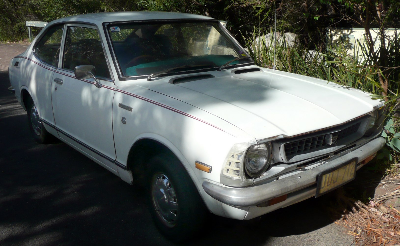 Classic compact coupe with round headlights and distinctive front grille