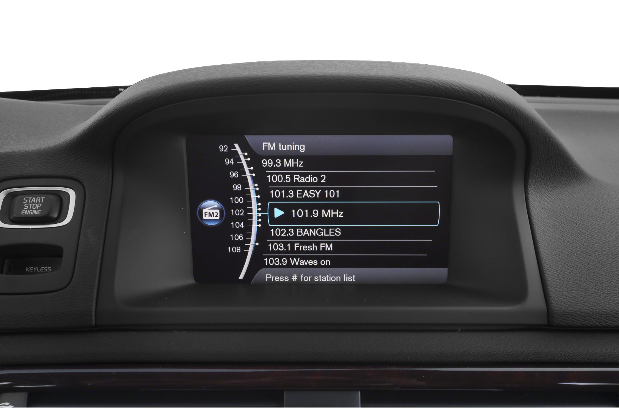 FM radio tuning screen and start/stop engine button on car dashboard