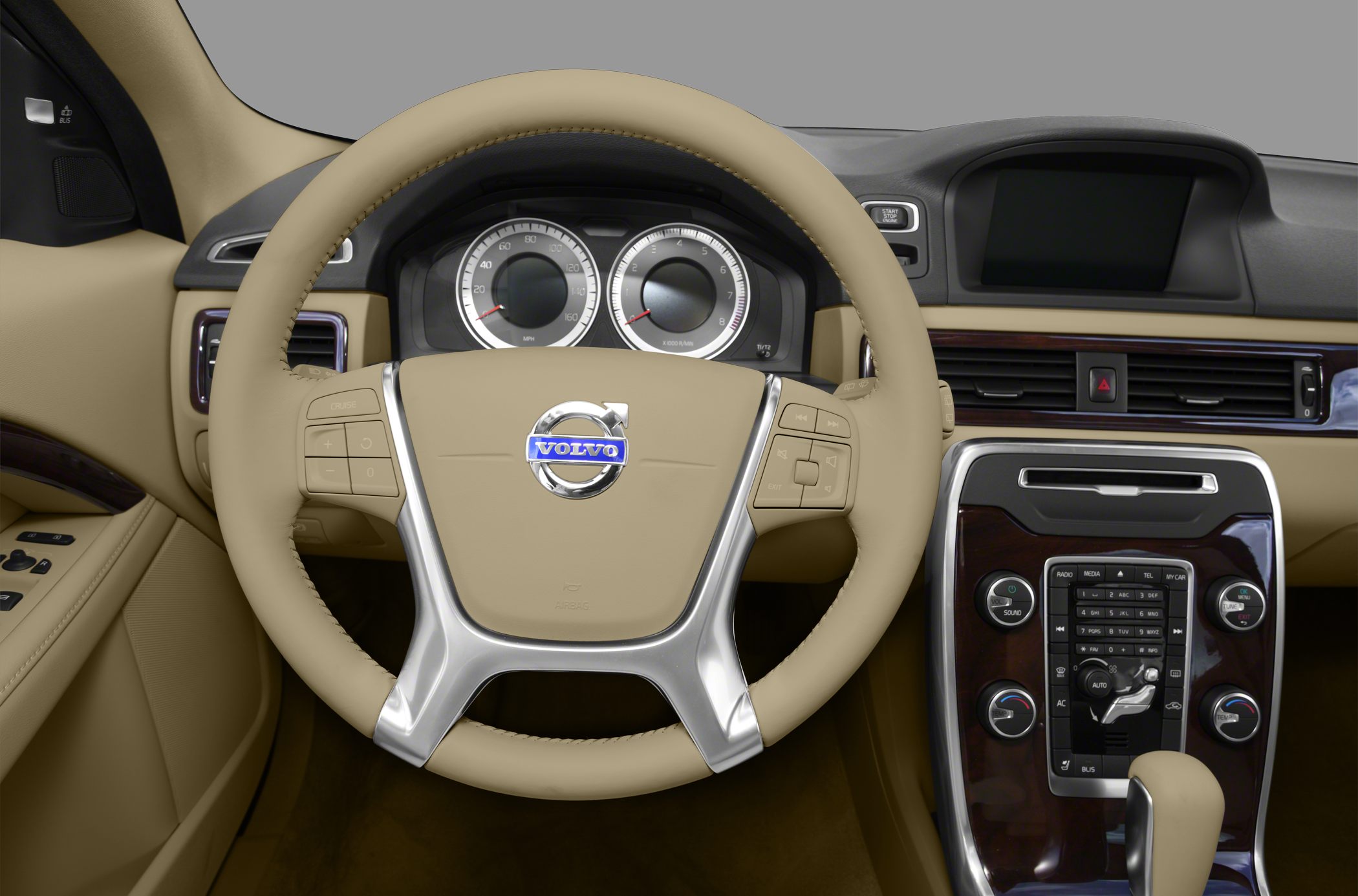Beige leather steering wheel and dashboard with control buttons and display.