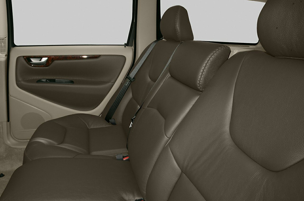 Brown leather rear seats with door panel and seatbelt
