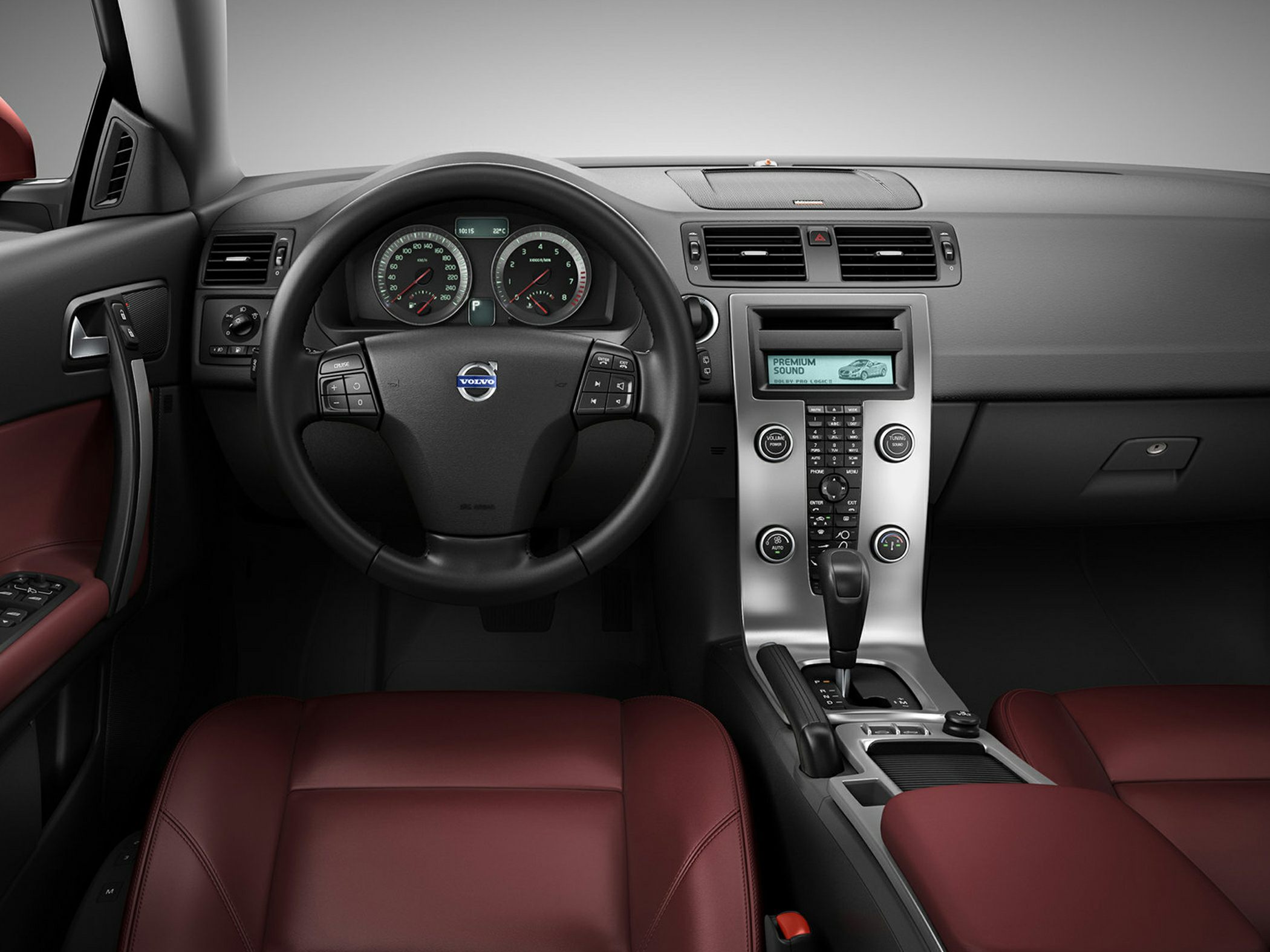 Steering wheel, dashboard gauges, and center console with controls and gearshift