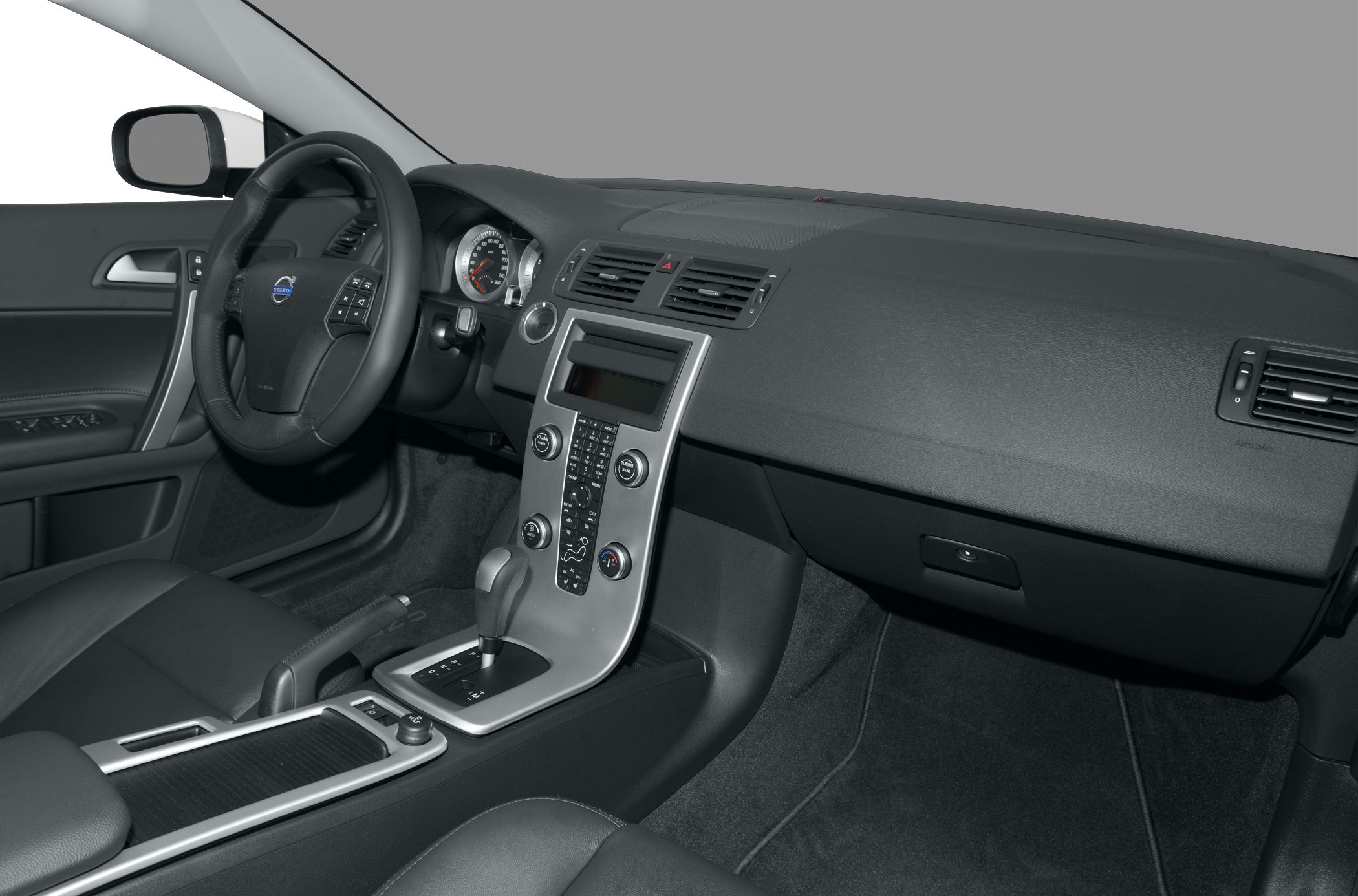 Car interior with dashboard, steering wheel, and center console.