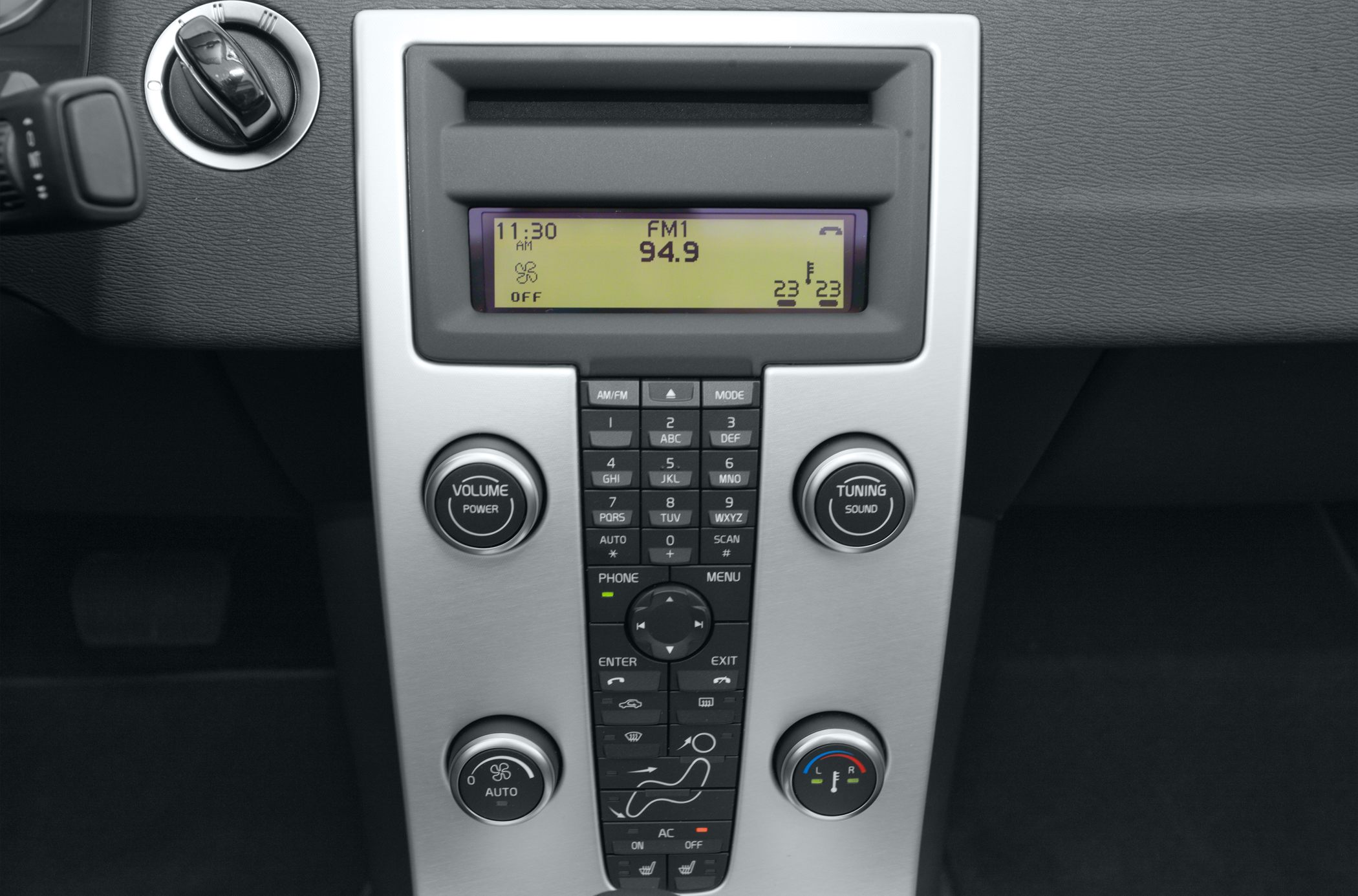 Digital radio display with volume/tuning knobs and climate control dials