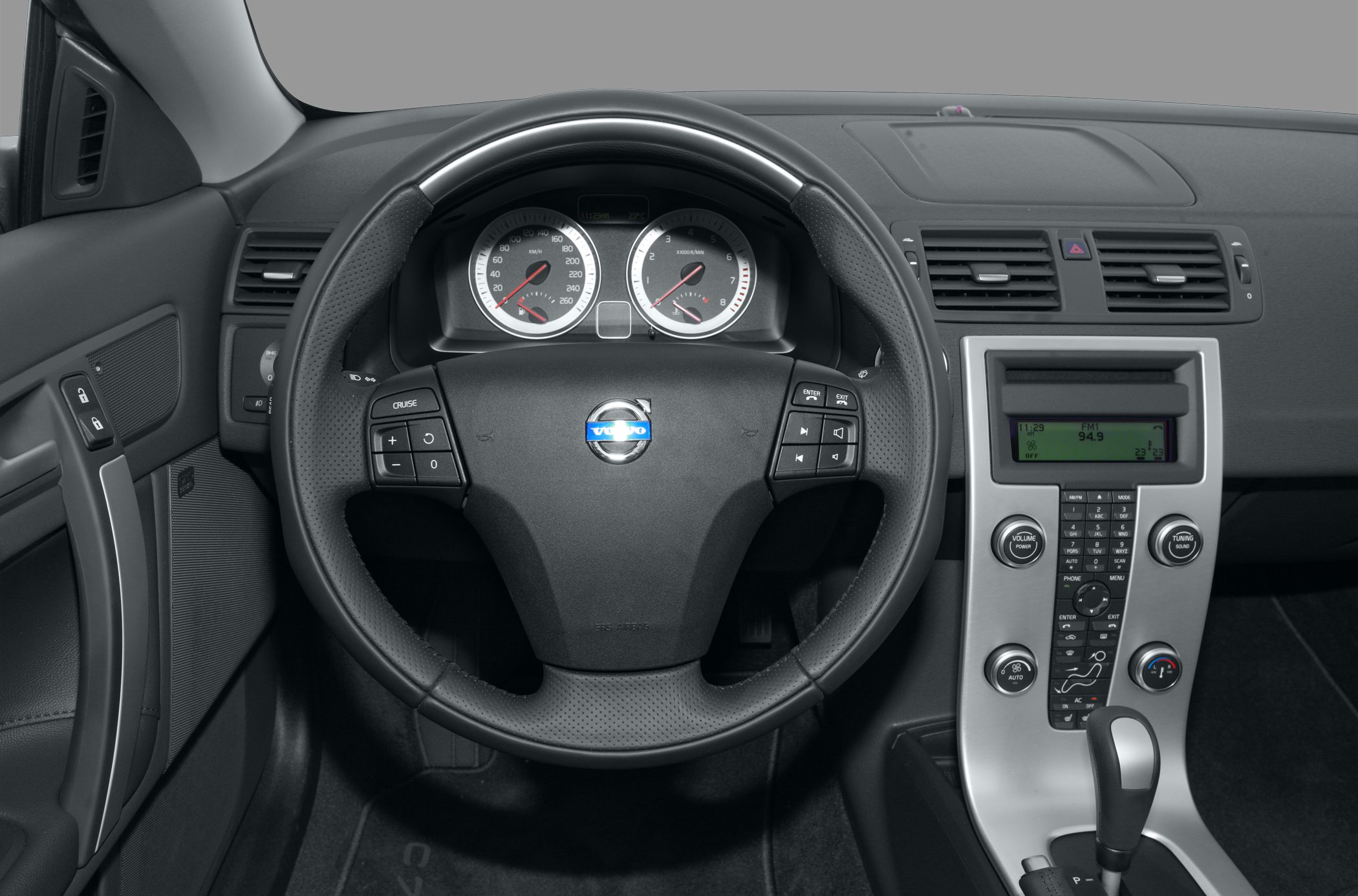 Interior view showing steering wheel, instrument cluster, and center console.