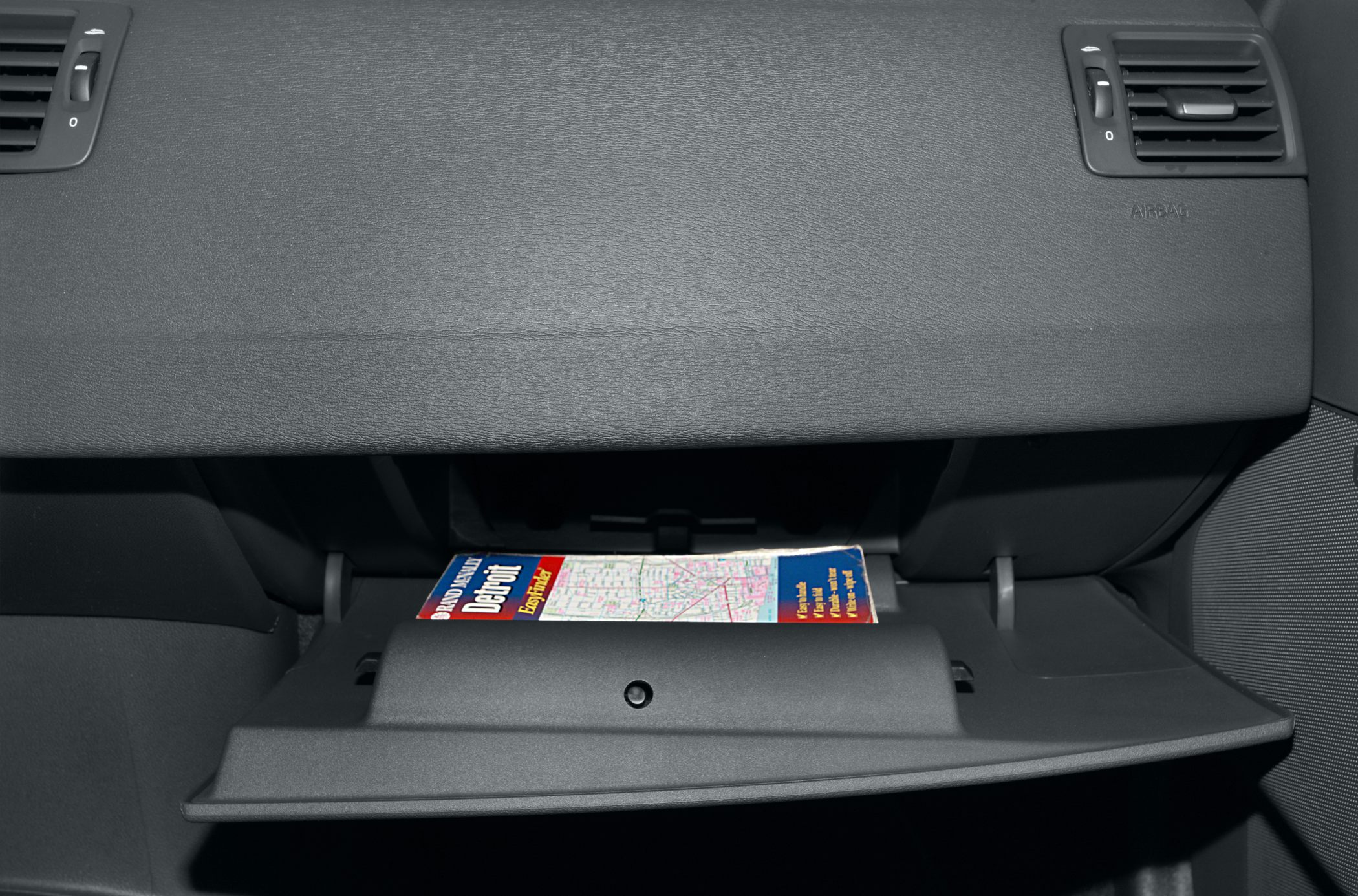 Open glove box with storage folder inside