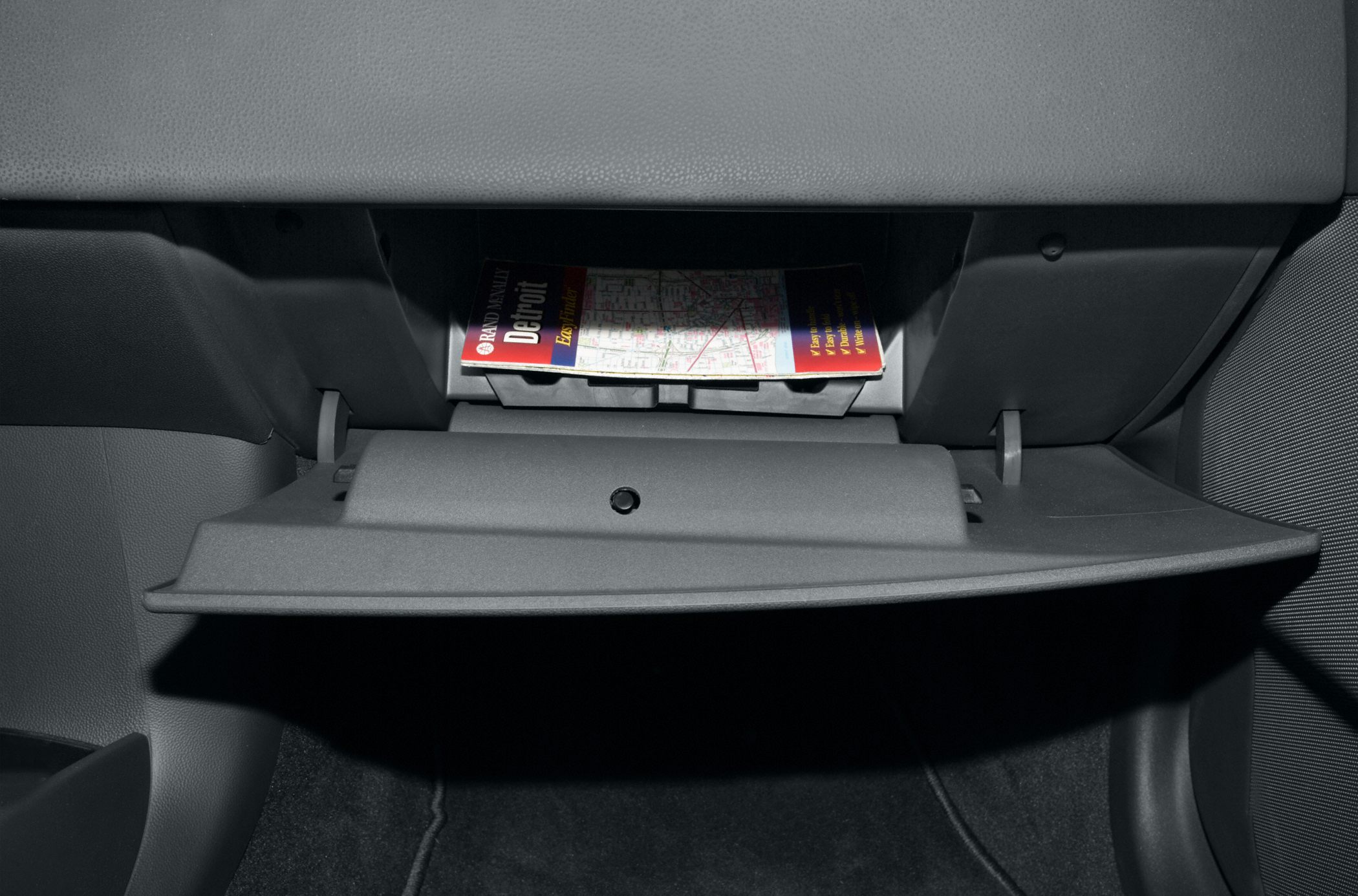 Open glove compartment with travel literature inside