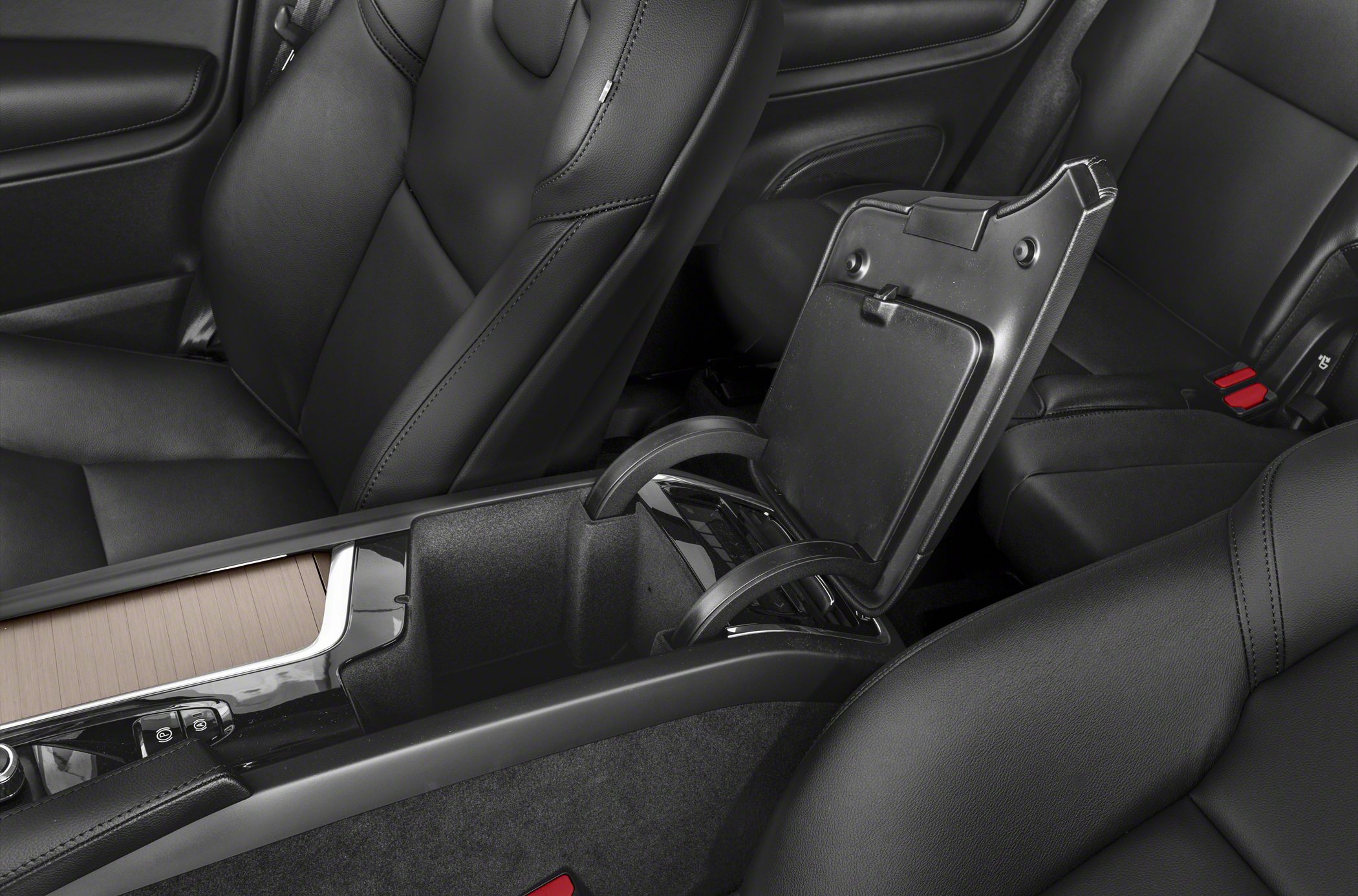 Center console storage with open armrest and black leather seats