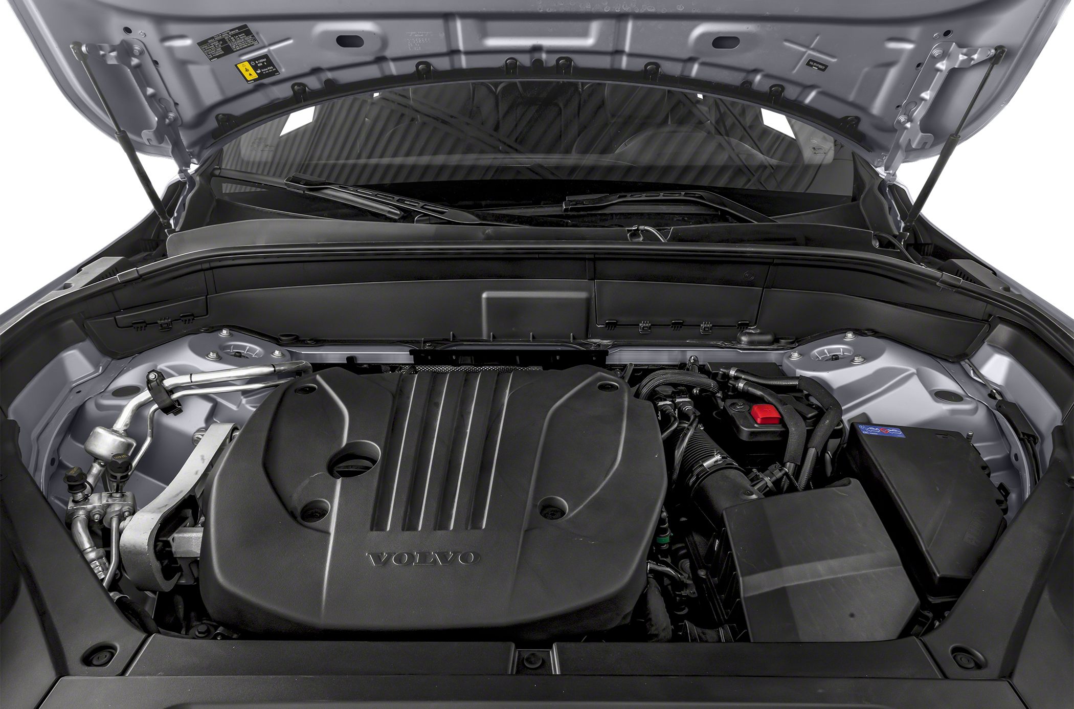 Engine compartment with large black engine cover and visible surrounding components