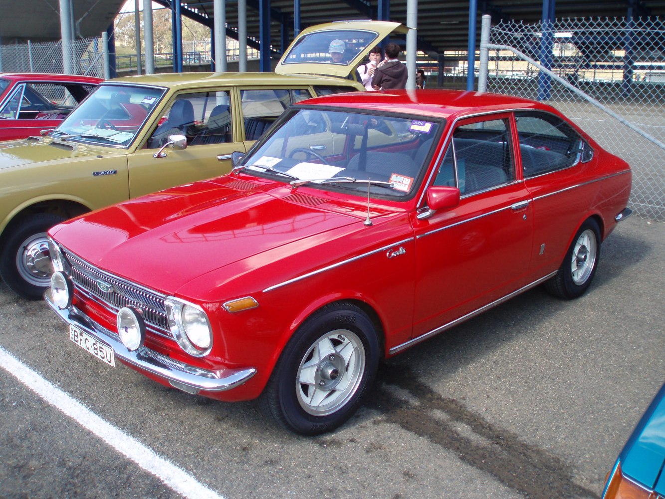 Compact two-door hatchback with round headlights and chrome grille