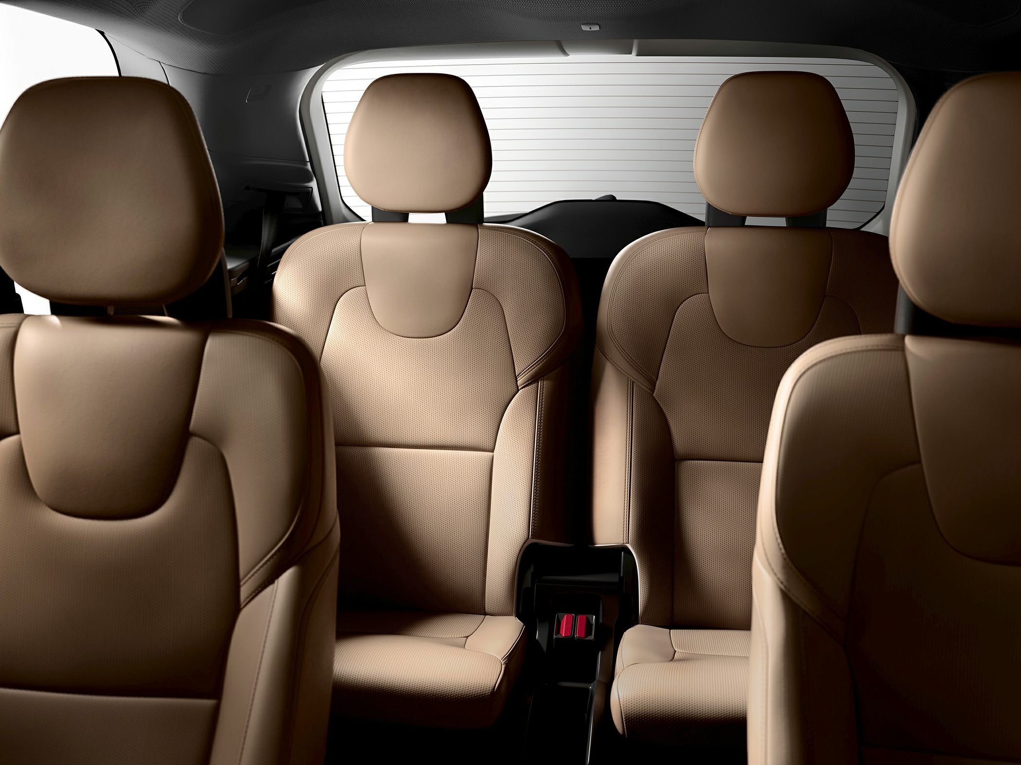 Luxurious brown leather three-row seats with headrests