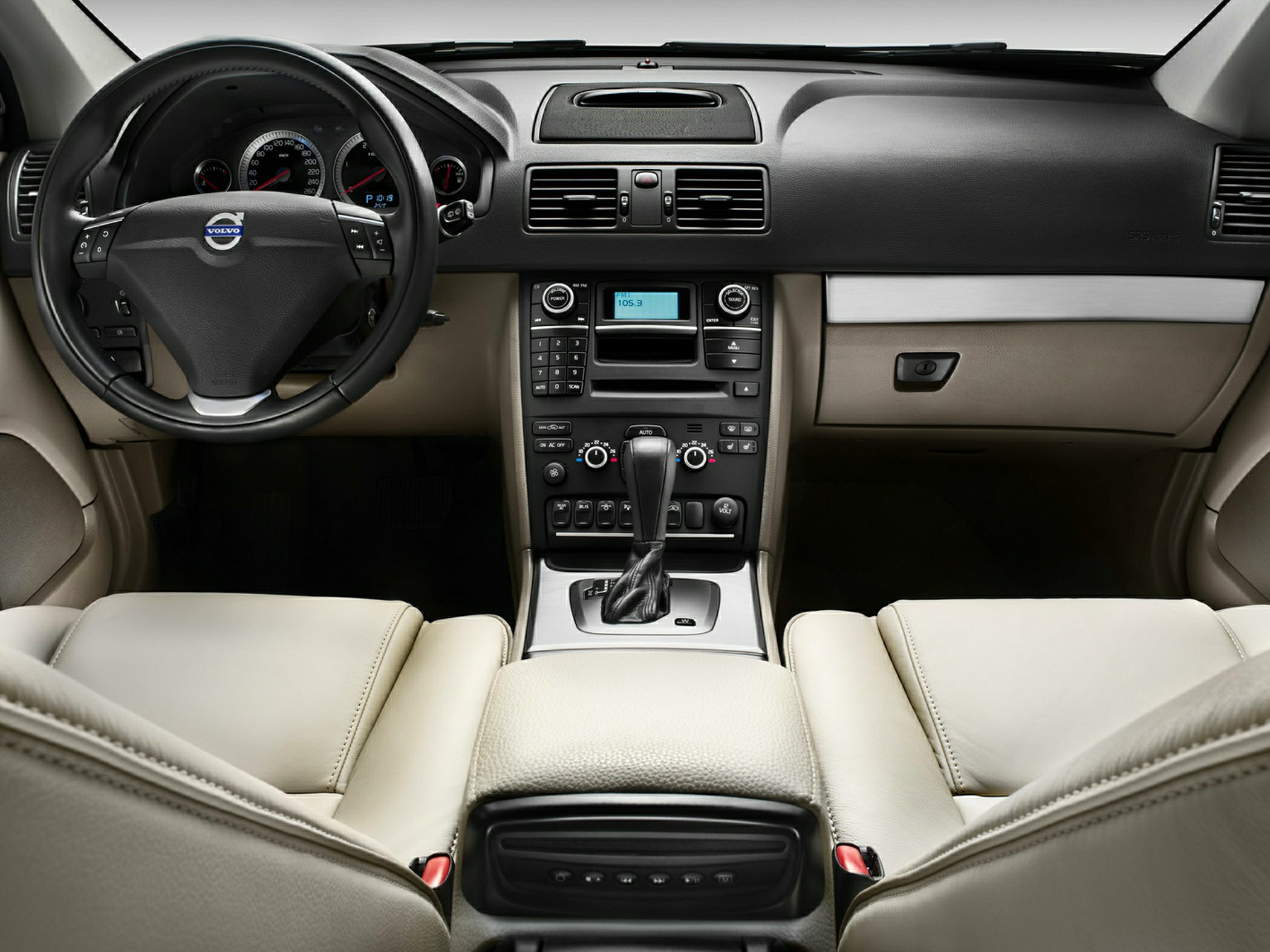 Dashboard and steering wheel with center console in luxury SUV interior.