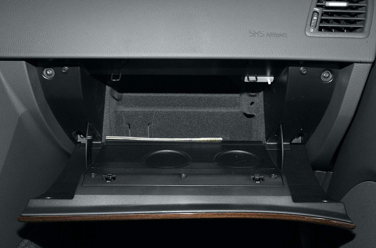 Open glove compartment with integrated cup holders and dashboard vent