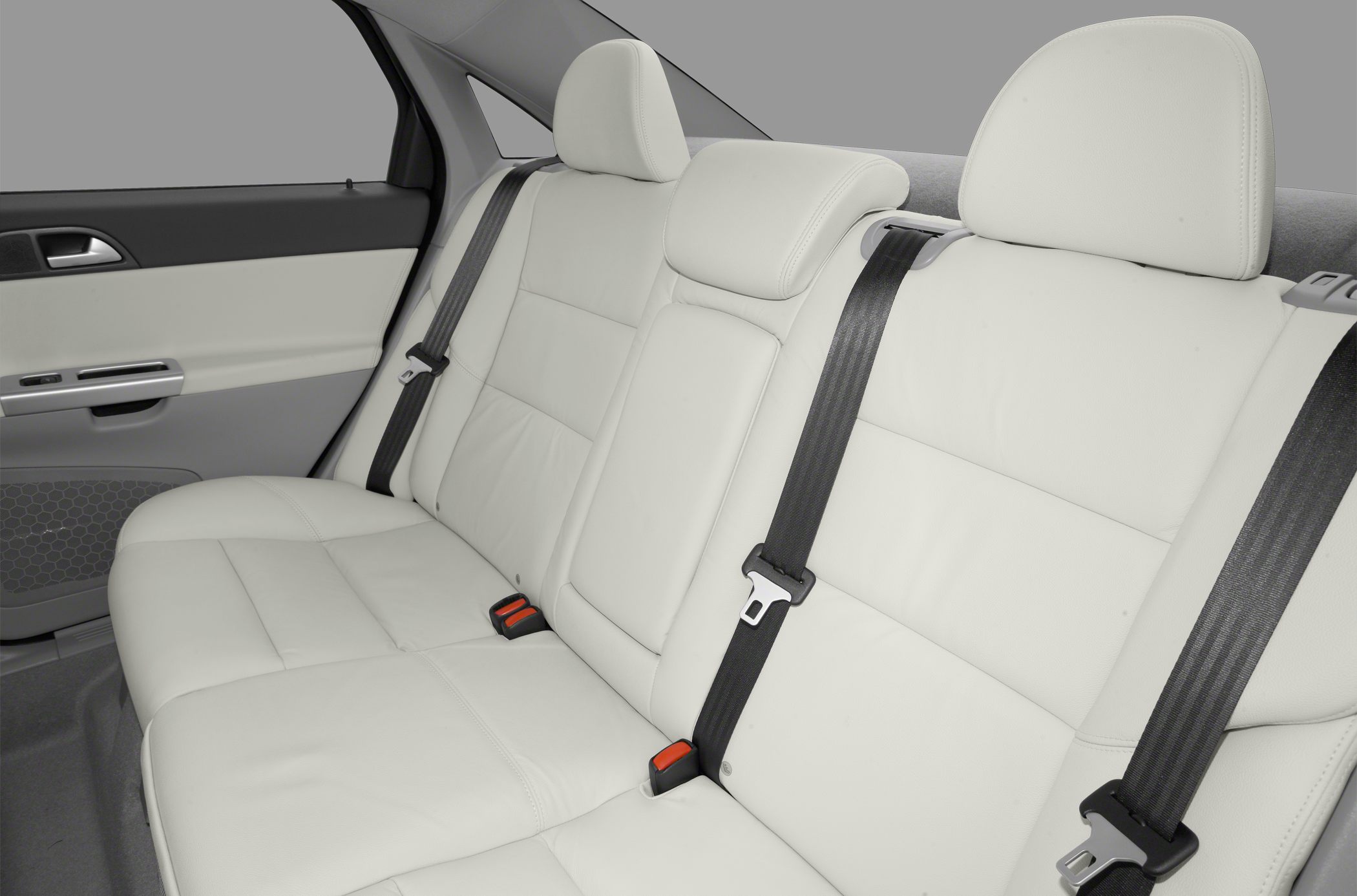 White leather rear seats with headrests and seatbelts