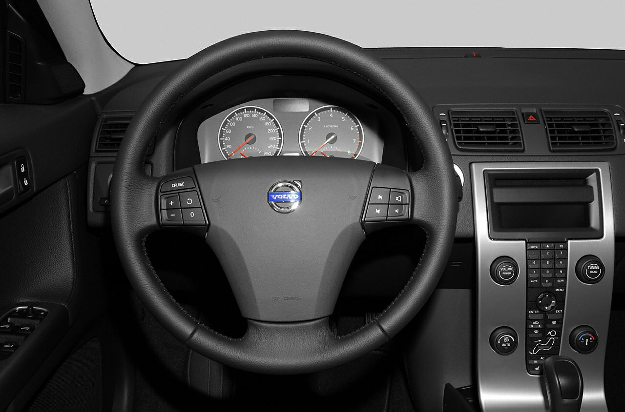 Steering wheel with control buttons and center console with climate and audio controls