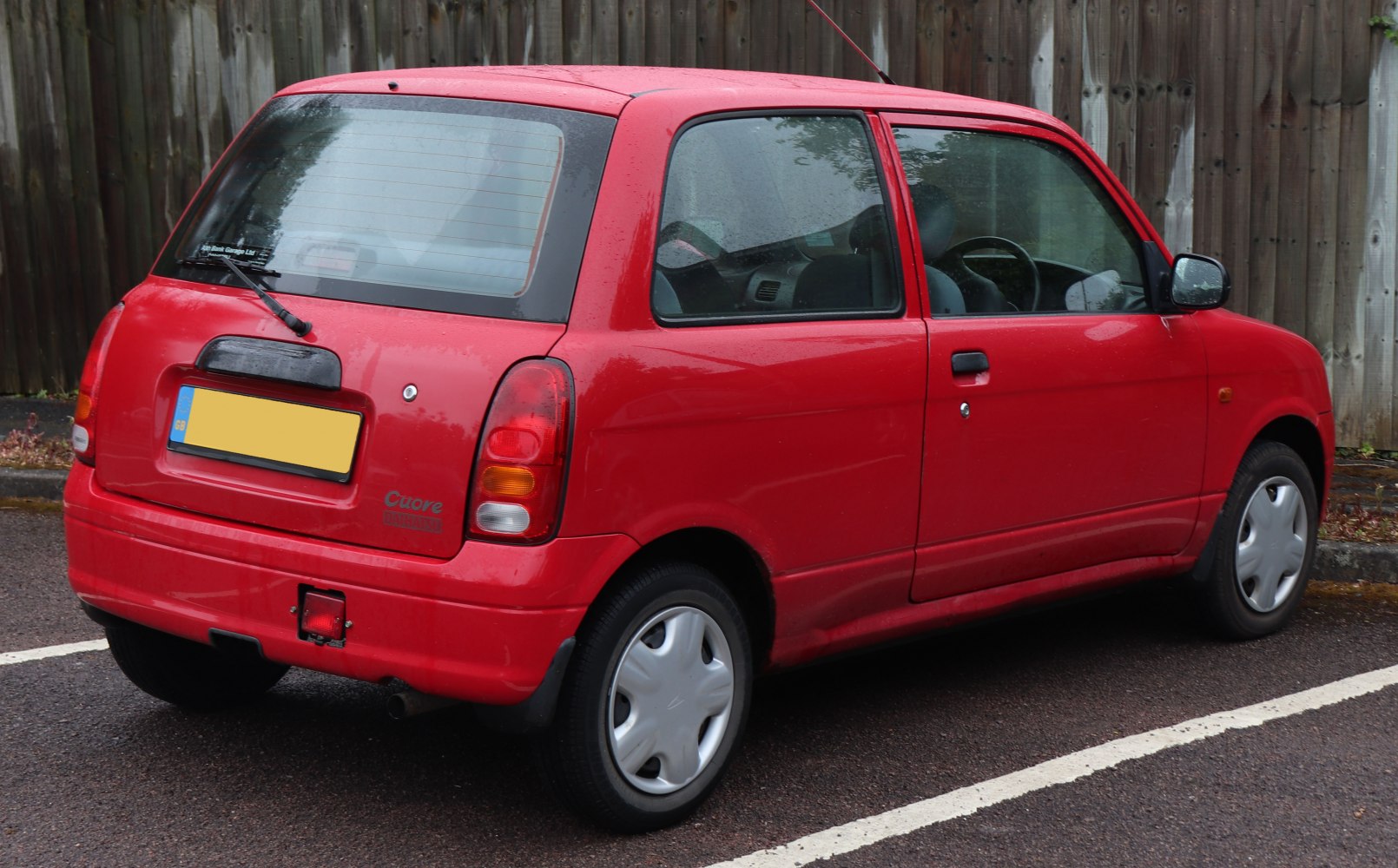 Rear and side view of compact hatchback with rounded tail lights and rear wiper