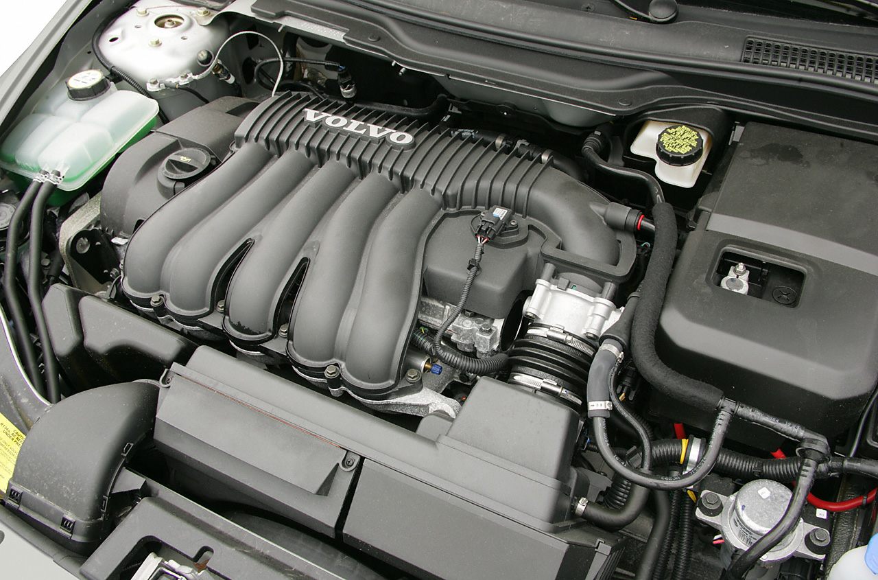 Close-up of intake manifold and engine components with wiring in engine bay