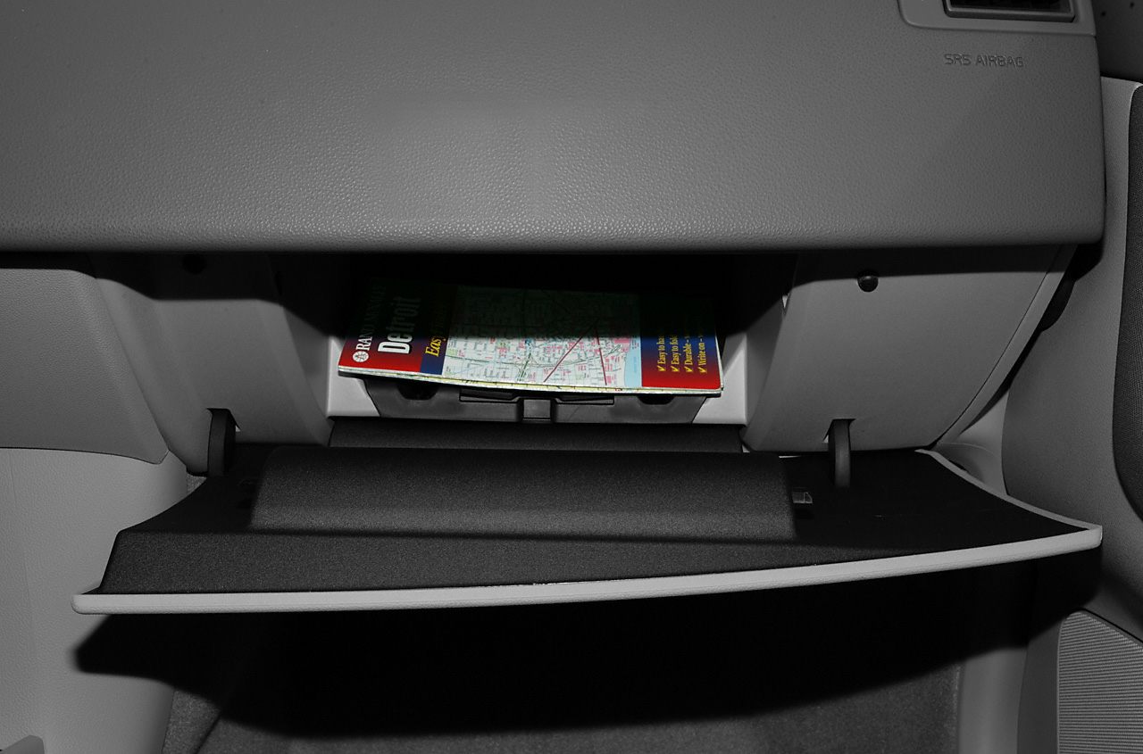 Open glove compartment with visible item inside