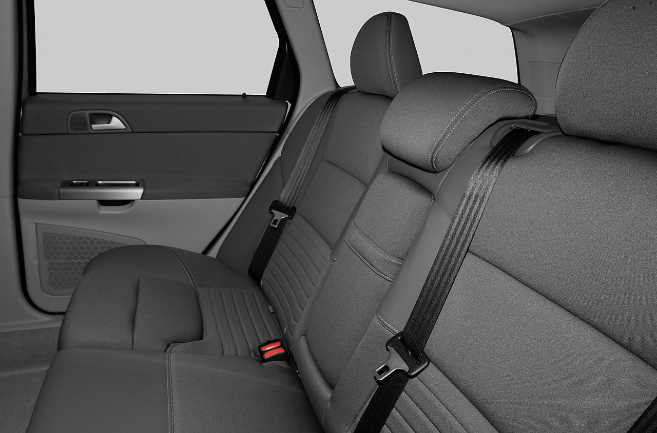 Rear seat upholstery with integrated seat belts and headrests