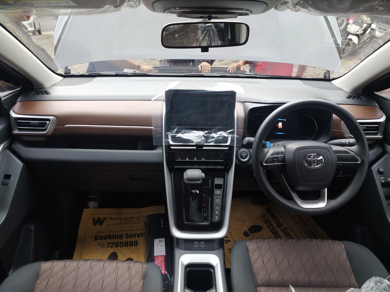 Modern car interior with central touchscreen and multifunction steering wheel