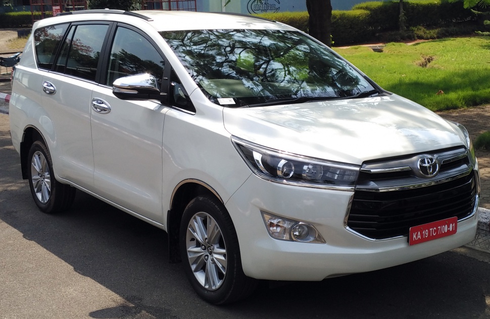 Front-side view with sleek headlights and chrome grille