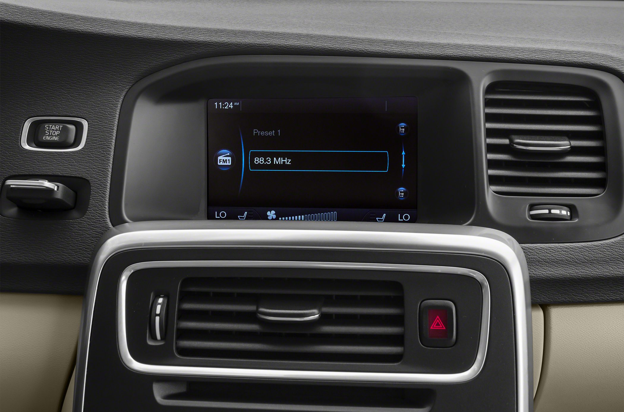 Dashboard air vents and infotainment display with radio frequency shown.