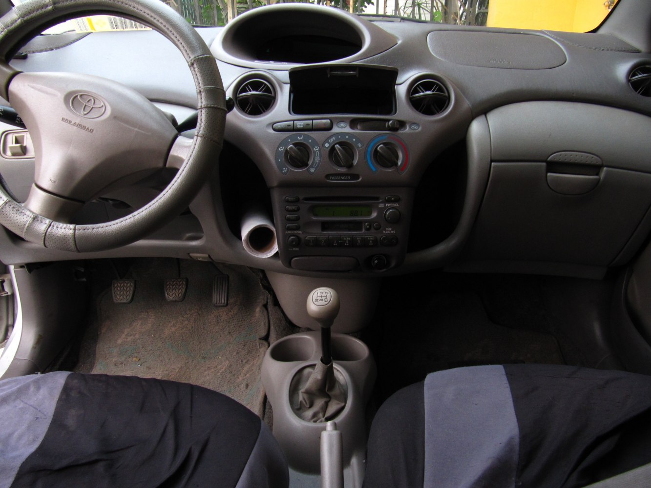 Car interior dashboard with manual gear shift and steering wheel
