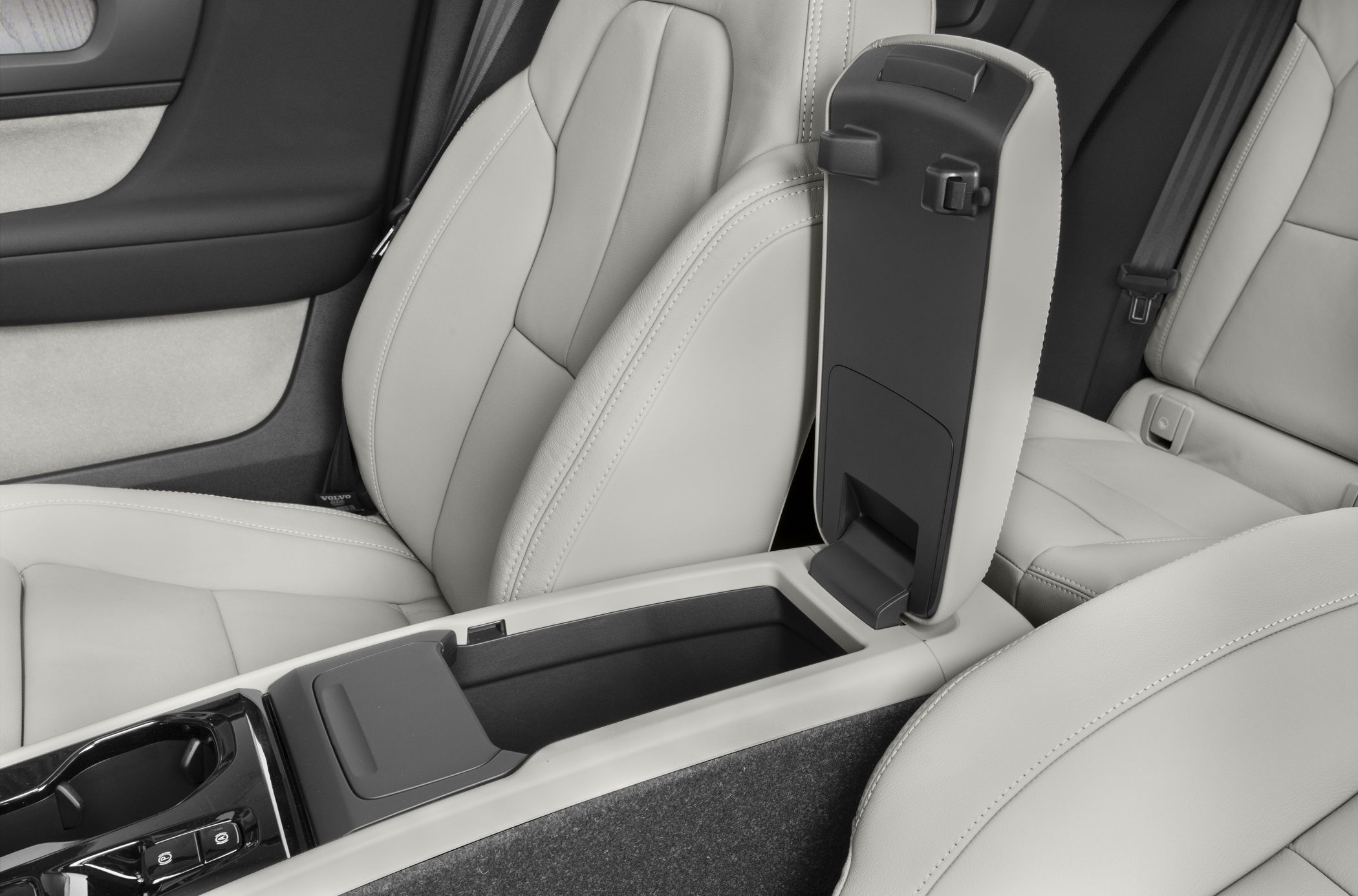 Center console storage with light-colored leather seats.