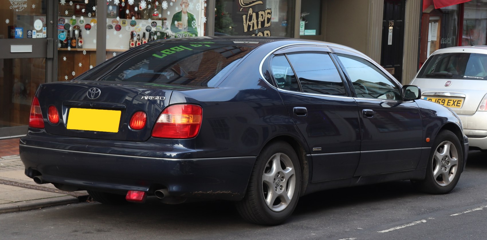 Rear side exterior with round taillight design and alloy wheels