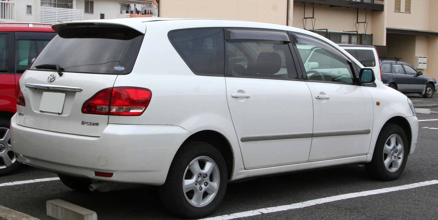 White compact MPV rear side with five doors and tinted windows