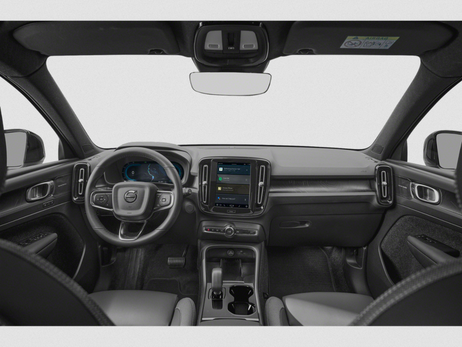 Modern dashboard and steering wheel with digital displays and touchscreen.