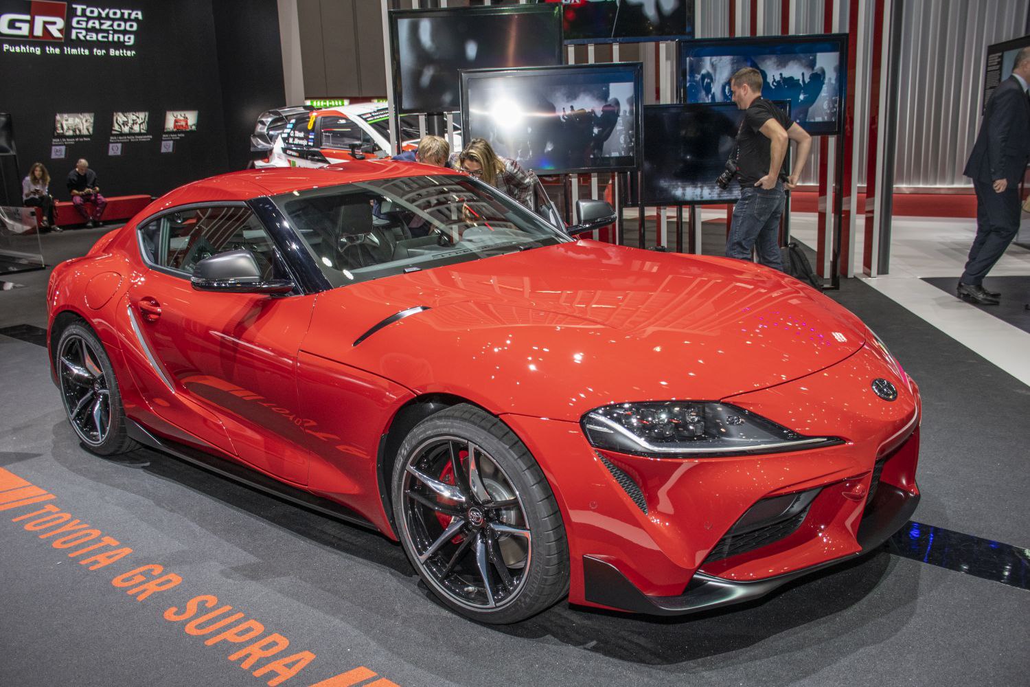 Red sports coupe with aerodynamic curves and black alloy wheels