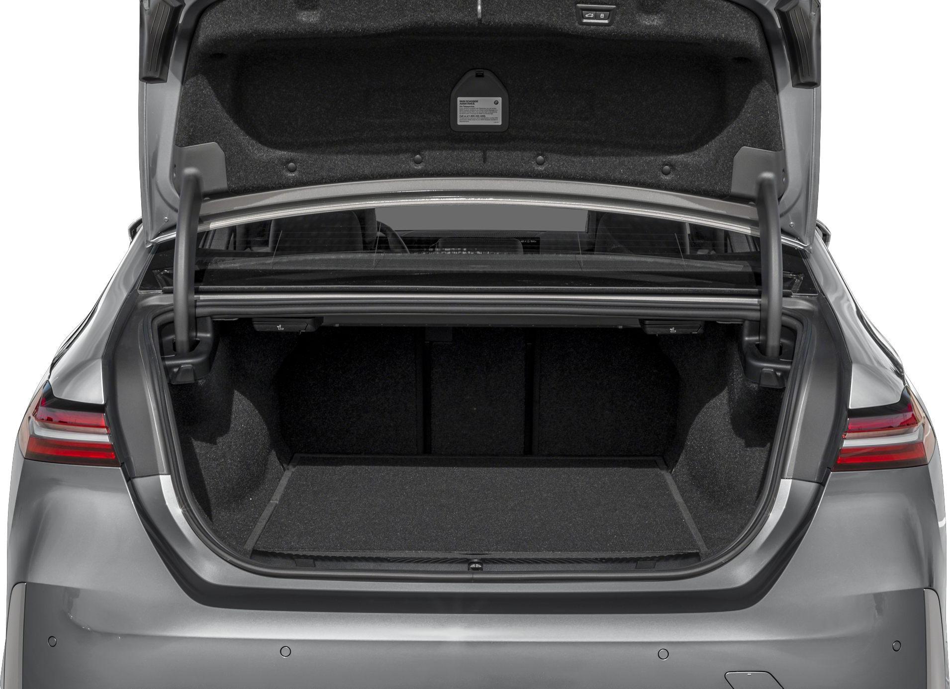 Open trunk interior with spacious, carpet-lined storage area and visible hydraulic supports.
