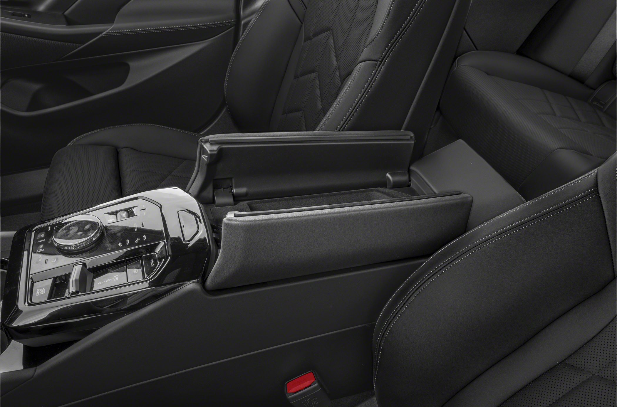 Center console controls and open armrest storage in black leather interior