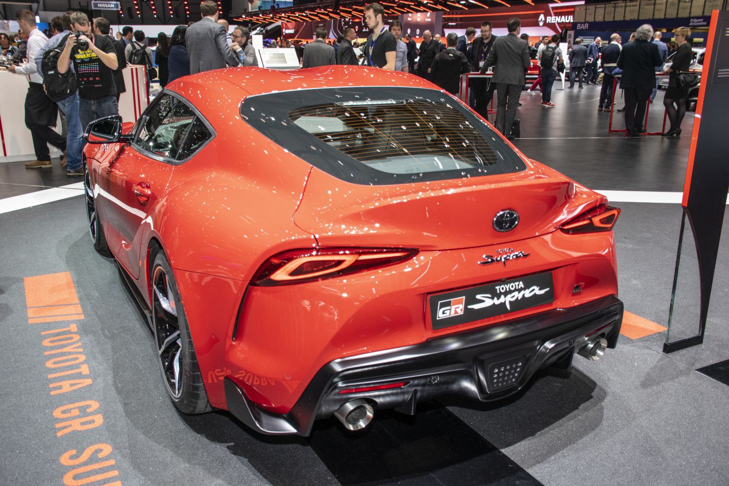 Rear view focused on sharp LED taillights and dual exhaust pipes of a sports coupe
