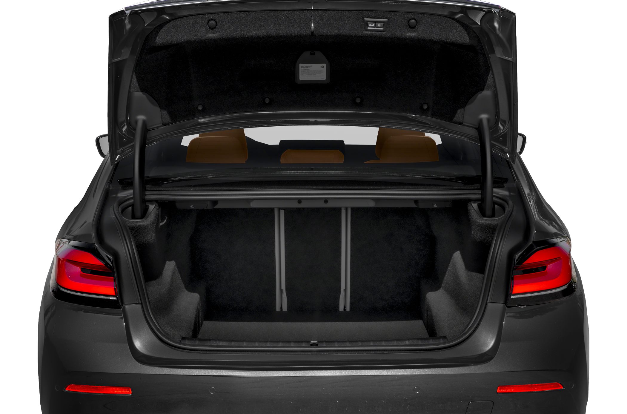 Spacious open trunk interior with foldable rear seats of a sedan