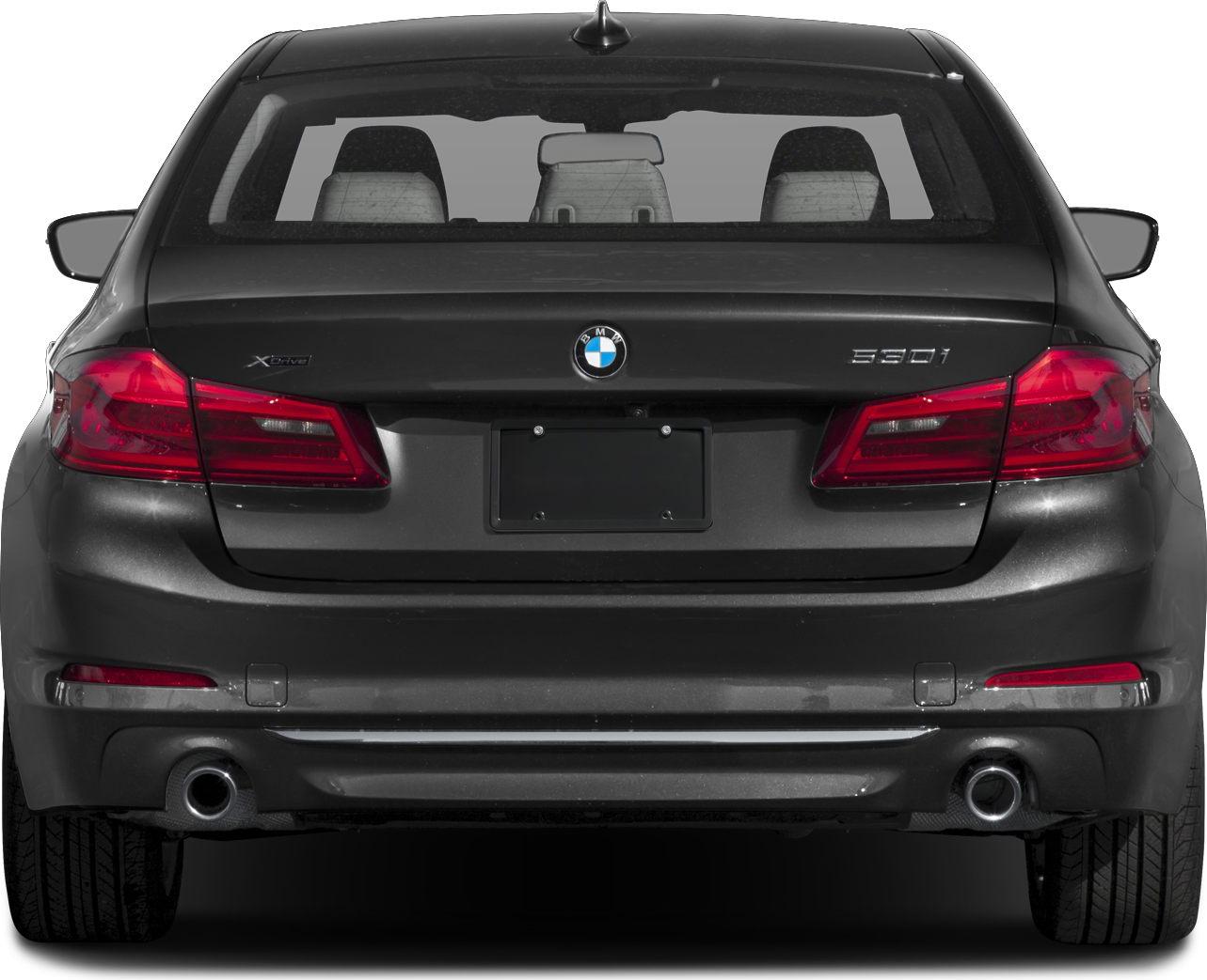 Rear view with taillights, exhaust pipes, and trunk lid of a sedan