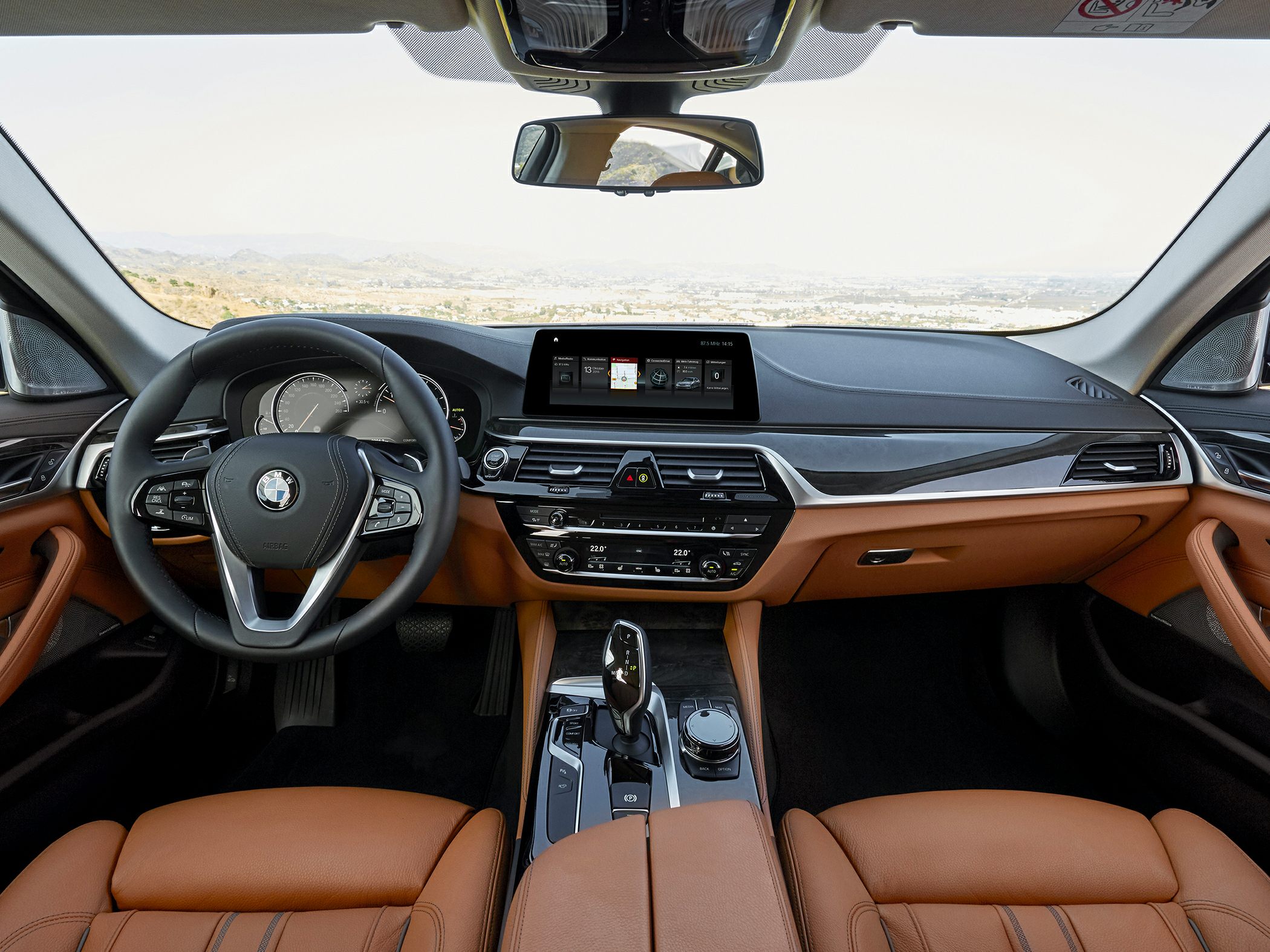 Luxury interior with dashboard, steering wheel, and leather seats