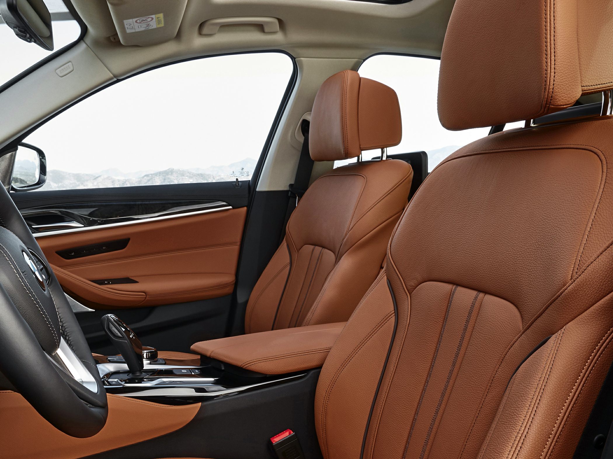 Brown leather seats with detailed stitching and premium car interior trims