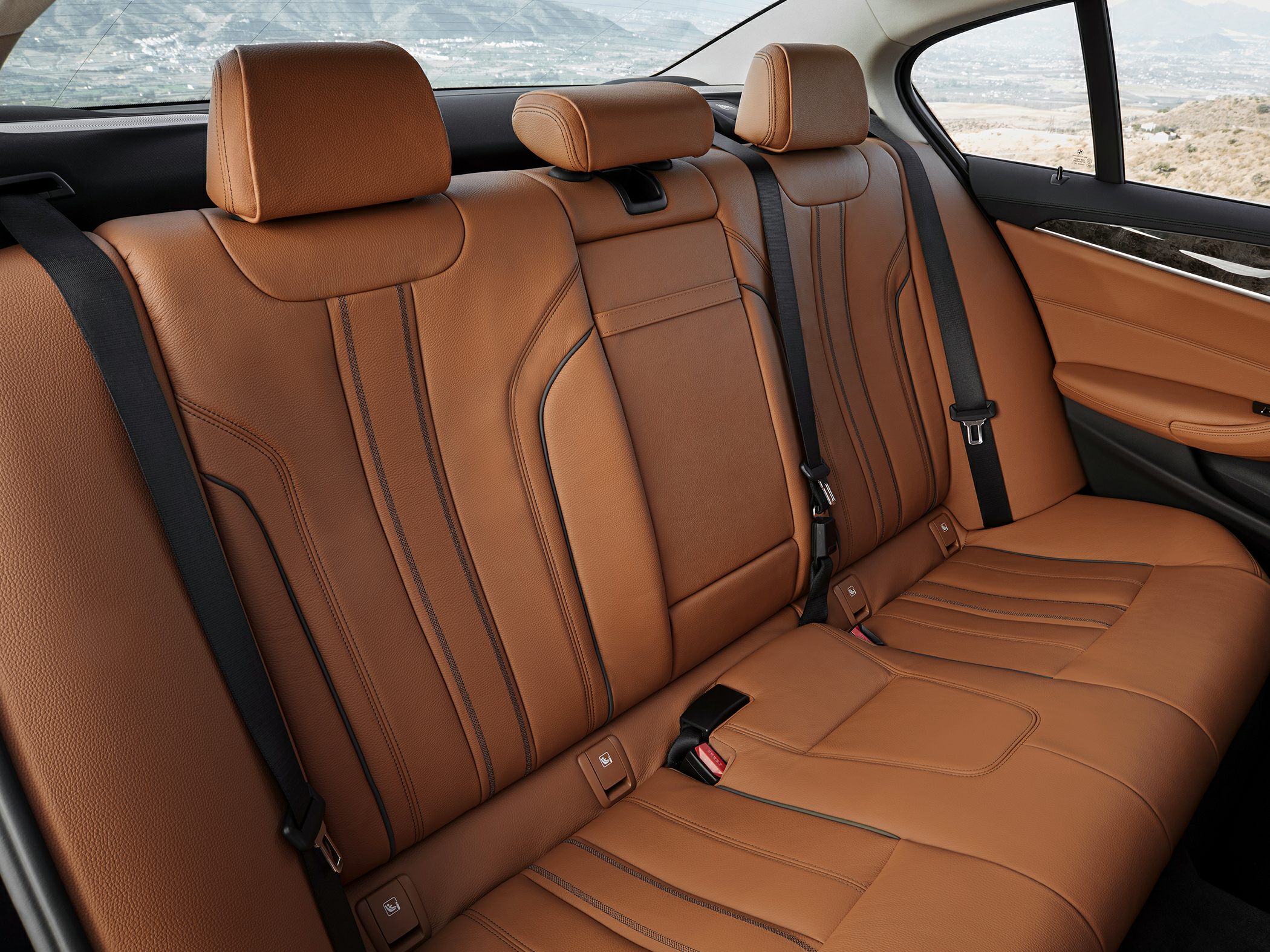 Brown leather rear seats with stitching and headrests