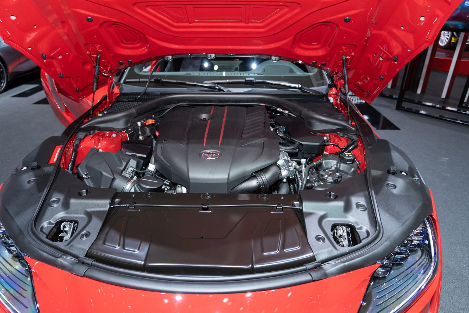 Open hood view of a modern performance engine bay with visible engine cover and components